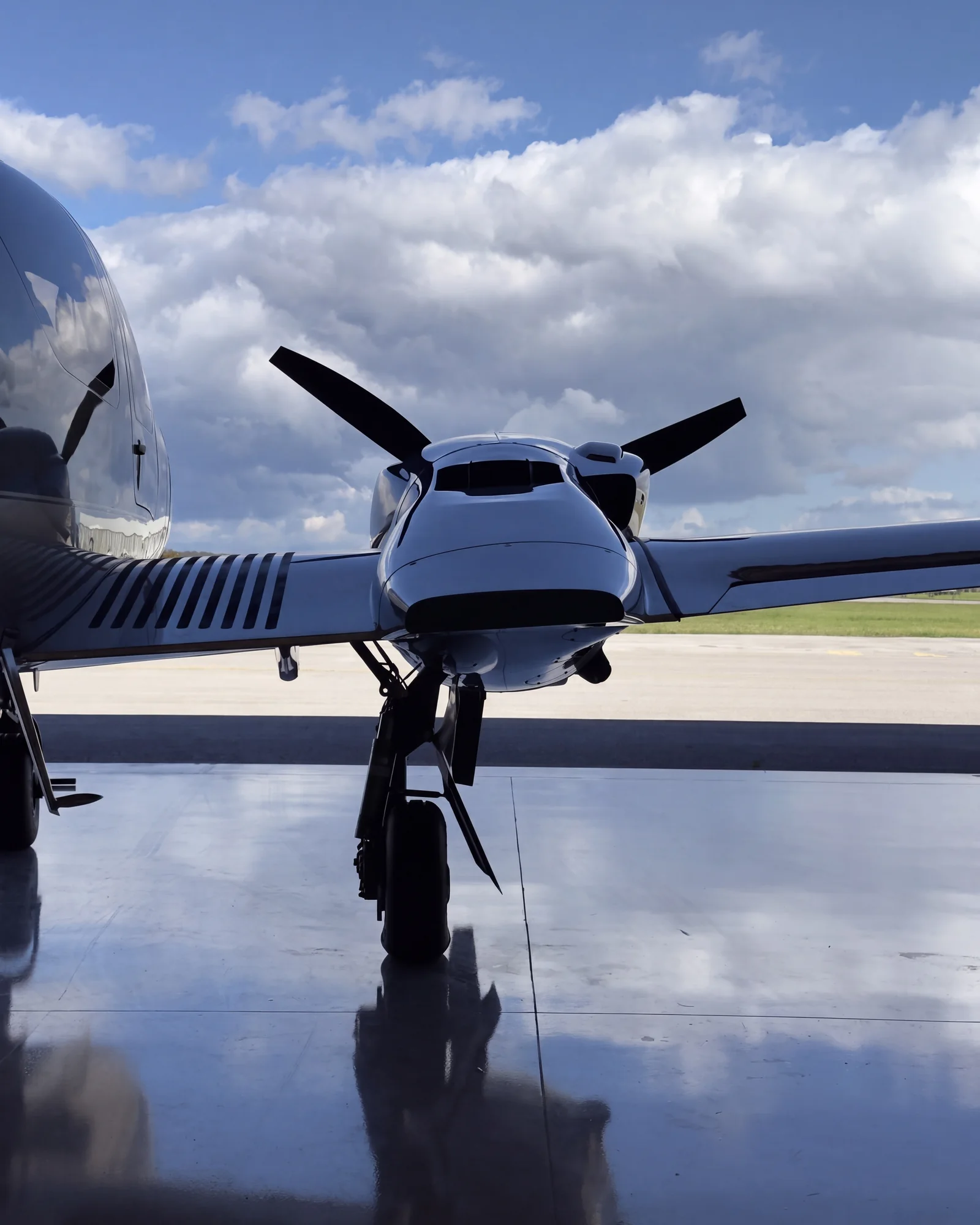 An engine and propeller of our DA62 against a cloudy sky