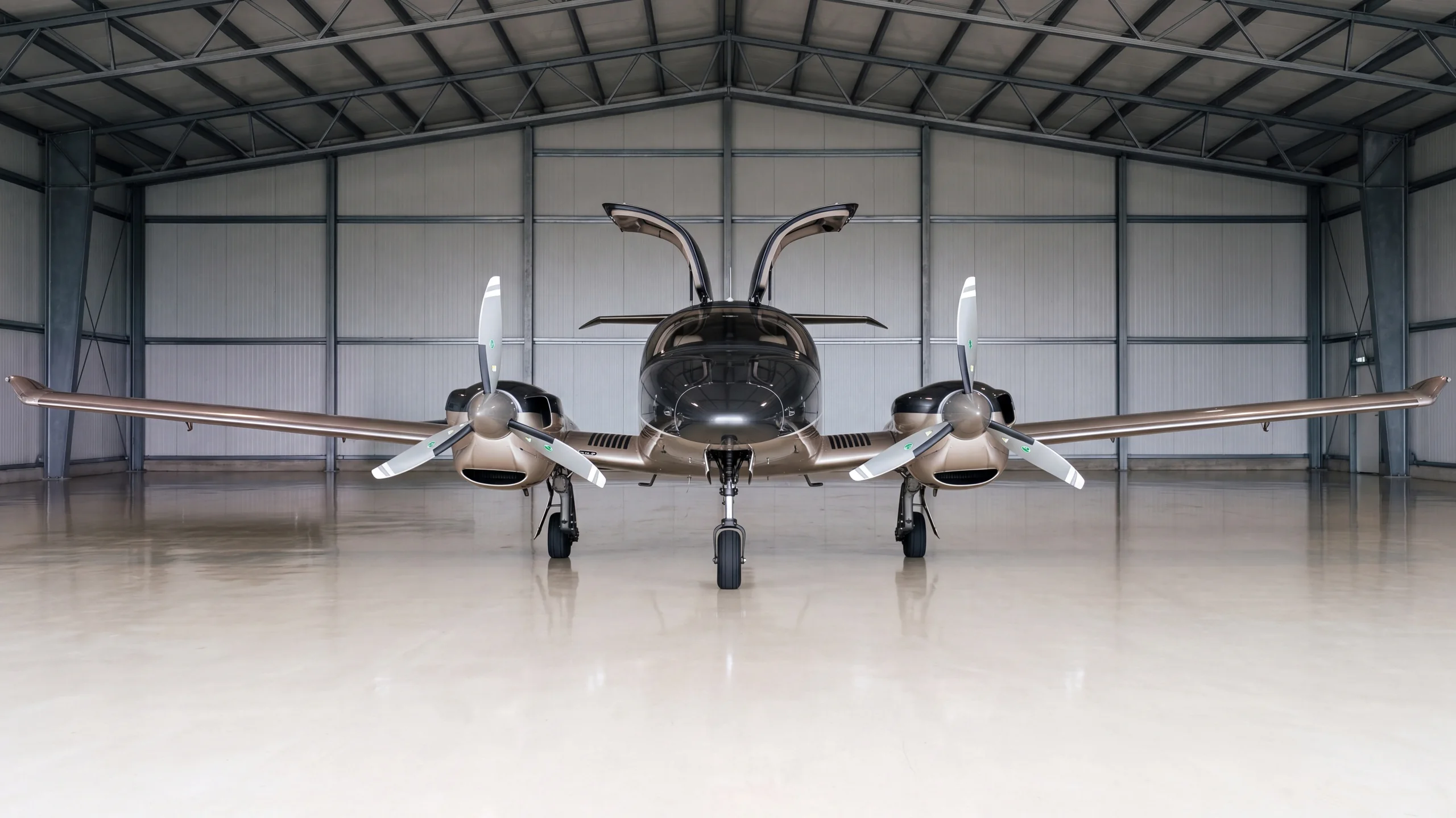 Our DA62 seen head-on in the hangar with its cabin doors open
