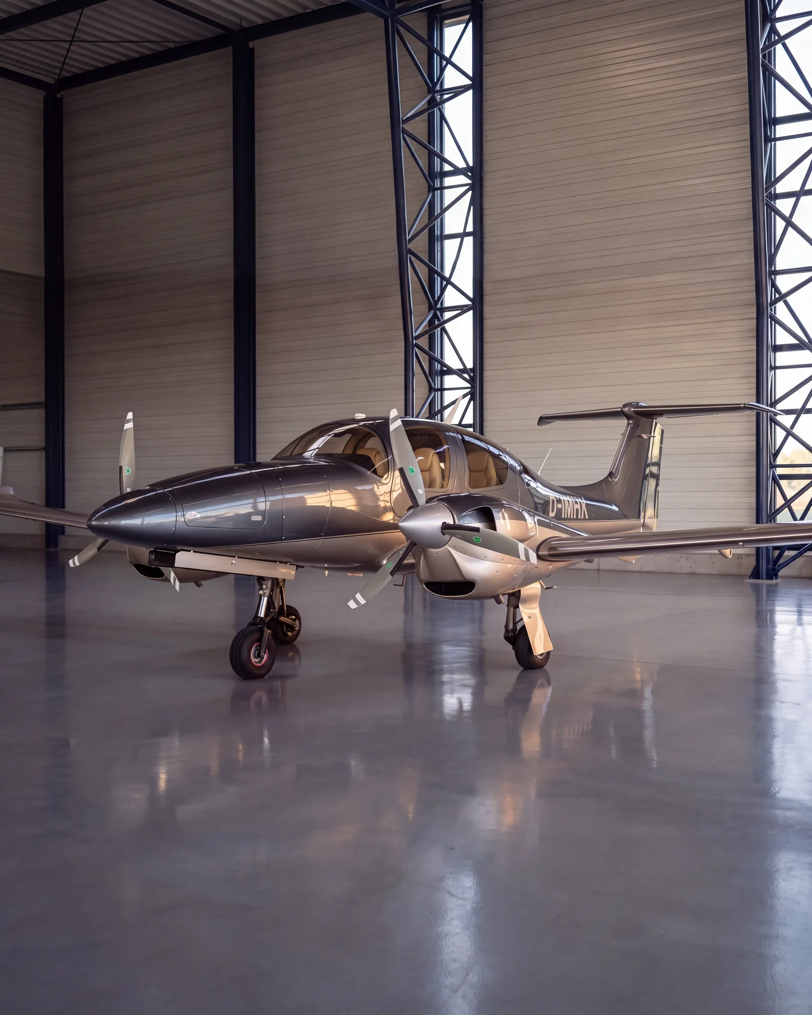 Our DA62 D-IMHK in side view in a bright hangar